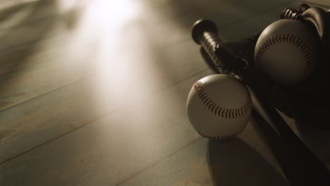 Backlit-Close-Up-Studio-Baseball-Still-Life-With-Bat-Ball-And-Catchers-Mitt-On-Aged-Wooden-Floor-2